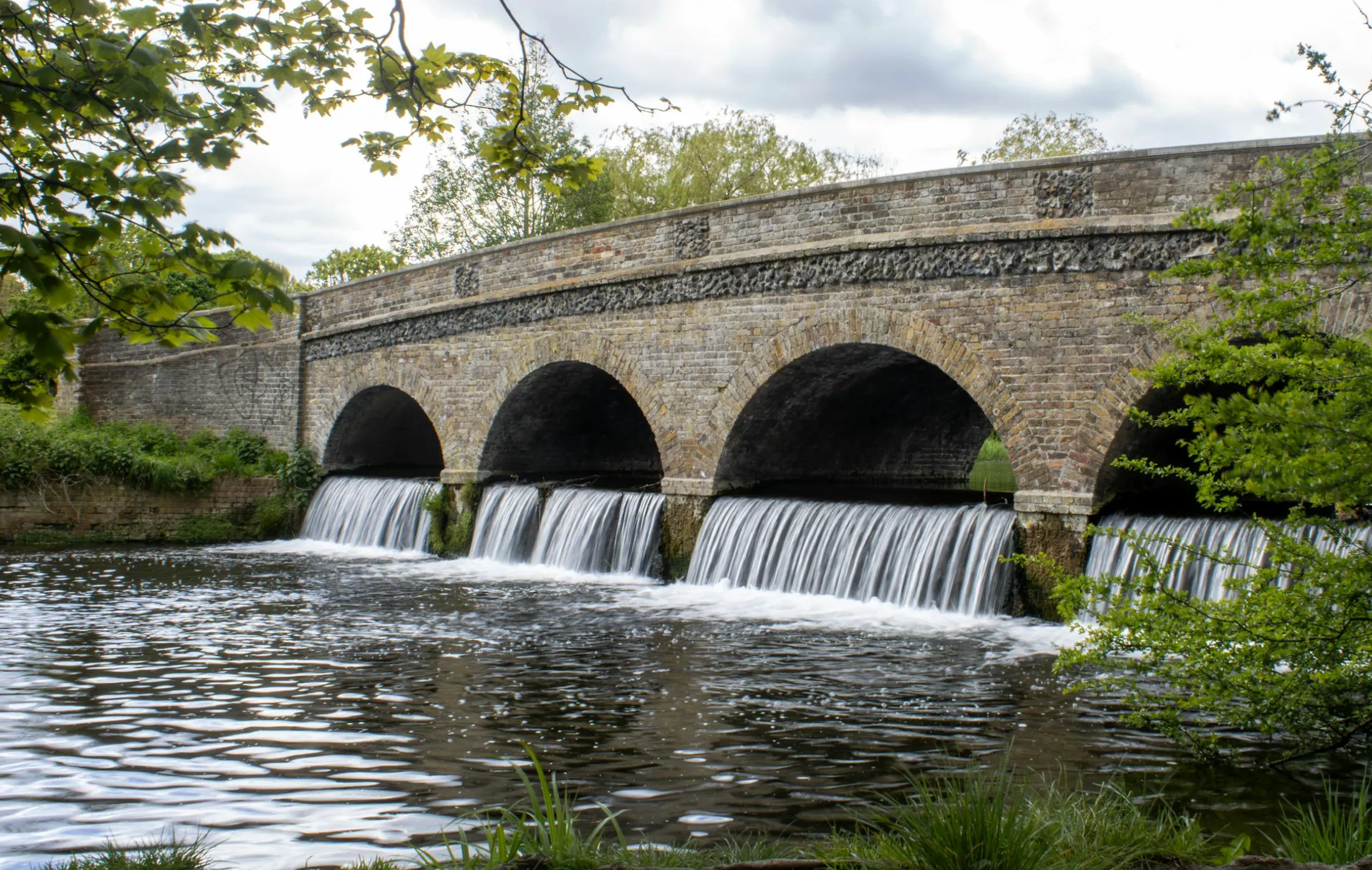 Close-up of a plumber’s hand checking water pressure at a Roseville home’s outdoor hose bib