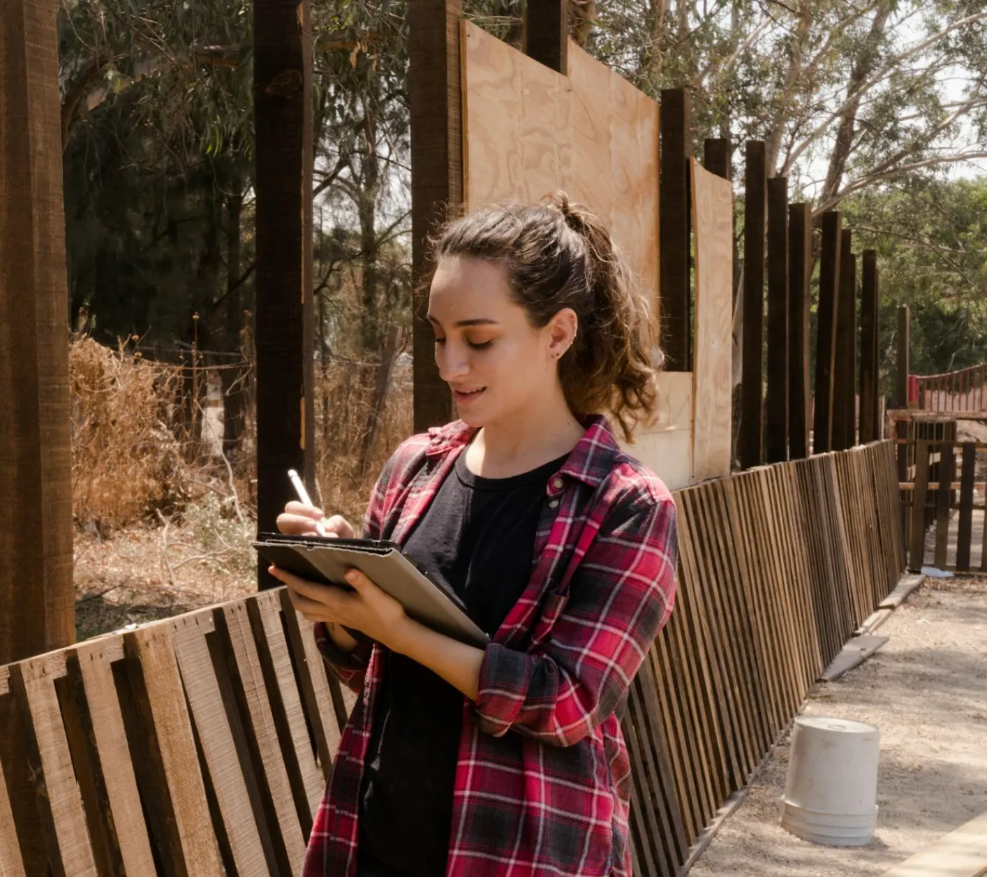 Young couple reviewing a plumbing inspection report with a plumber at a dining table