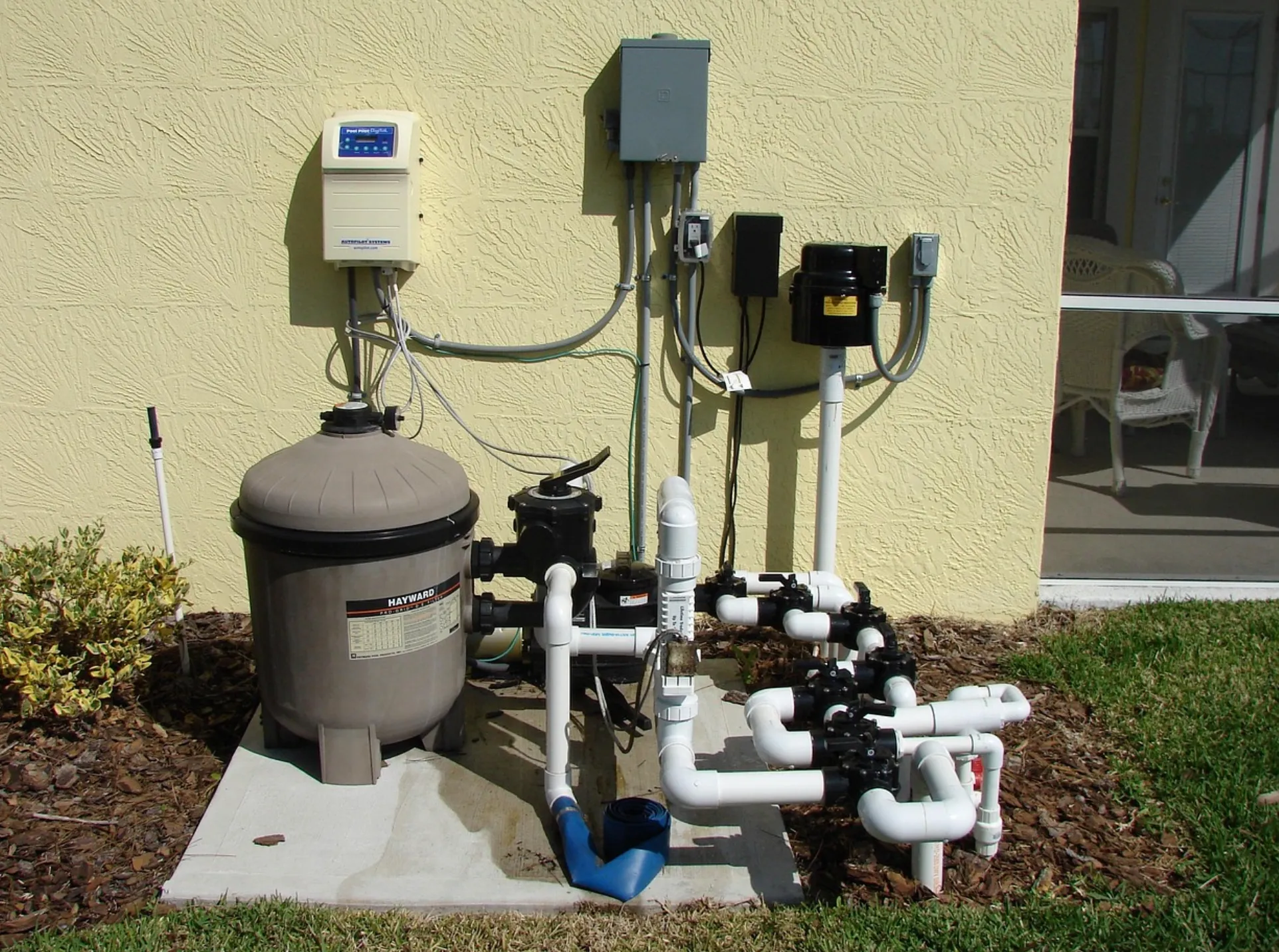 A licensed plumber testing tap water in a Sacramento kitchen with a small test kit