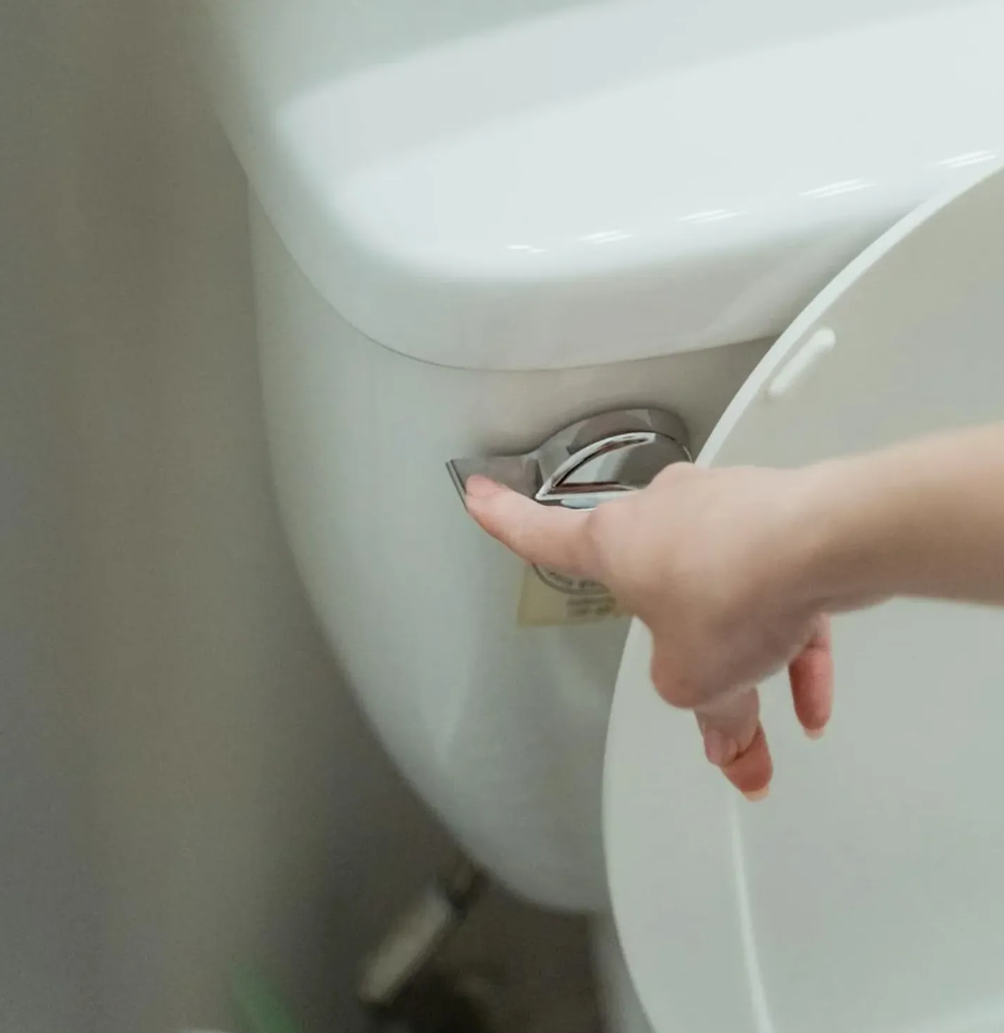 A new universal fill valve kit placed next to an old corroded fill valve removed from a toilet tank.